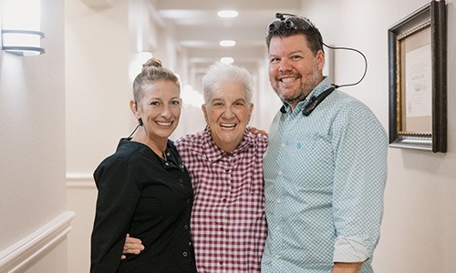 Dr. Miller posing with happy dental implant patient