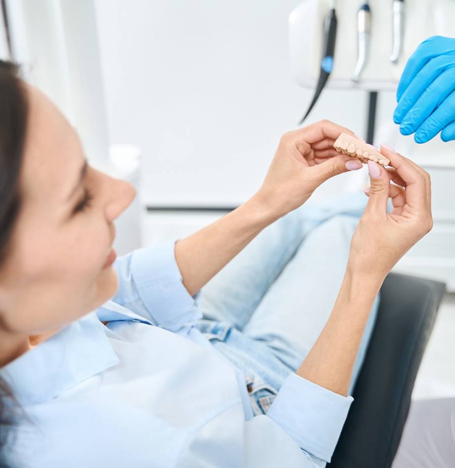 Dentist using model to explain treatment plan to patient