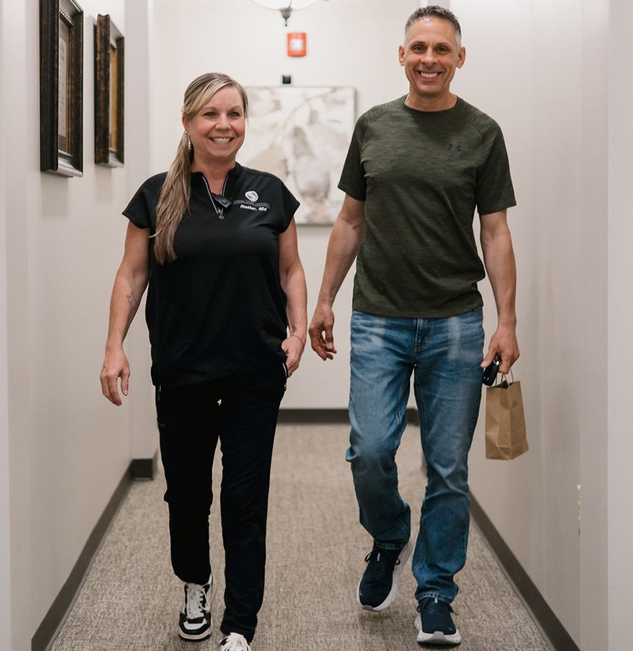Happy patient walking with Spring Creek Dentistry team member