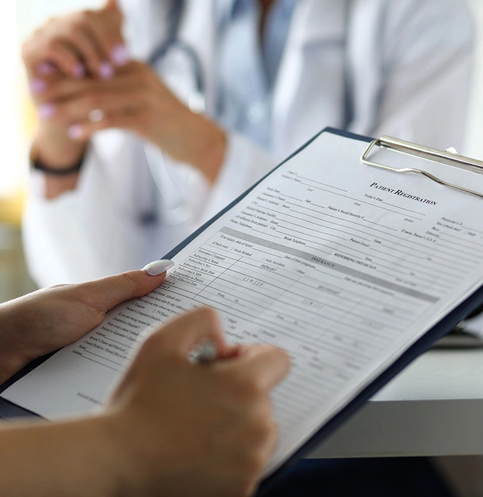 a patient filling out forms at a dental office