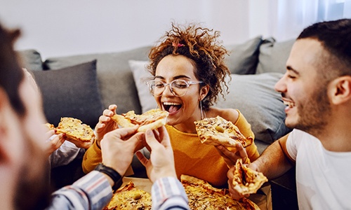 Group of friends enjoying pizza together
