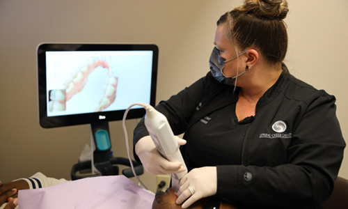 Dental member using scanner on patient’s mouth 