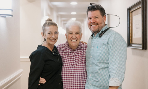 Patient smiling with dental team 