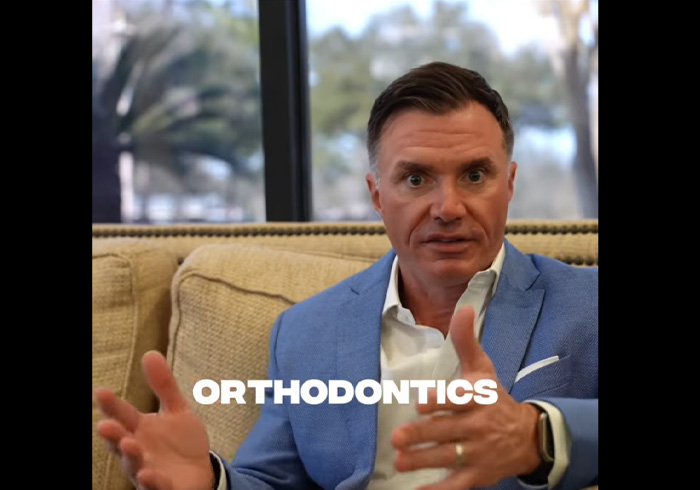 Smiling man with Candid Pro clear aligners