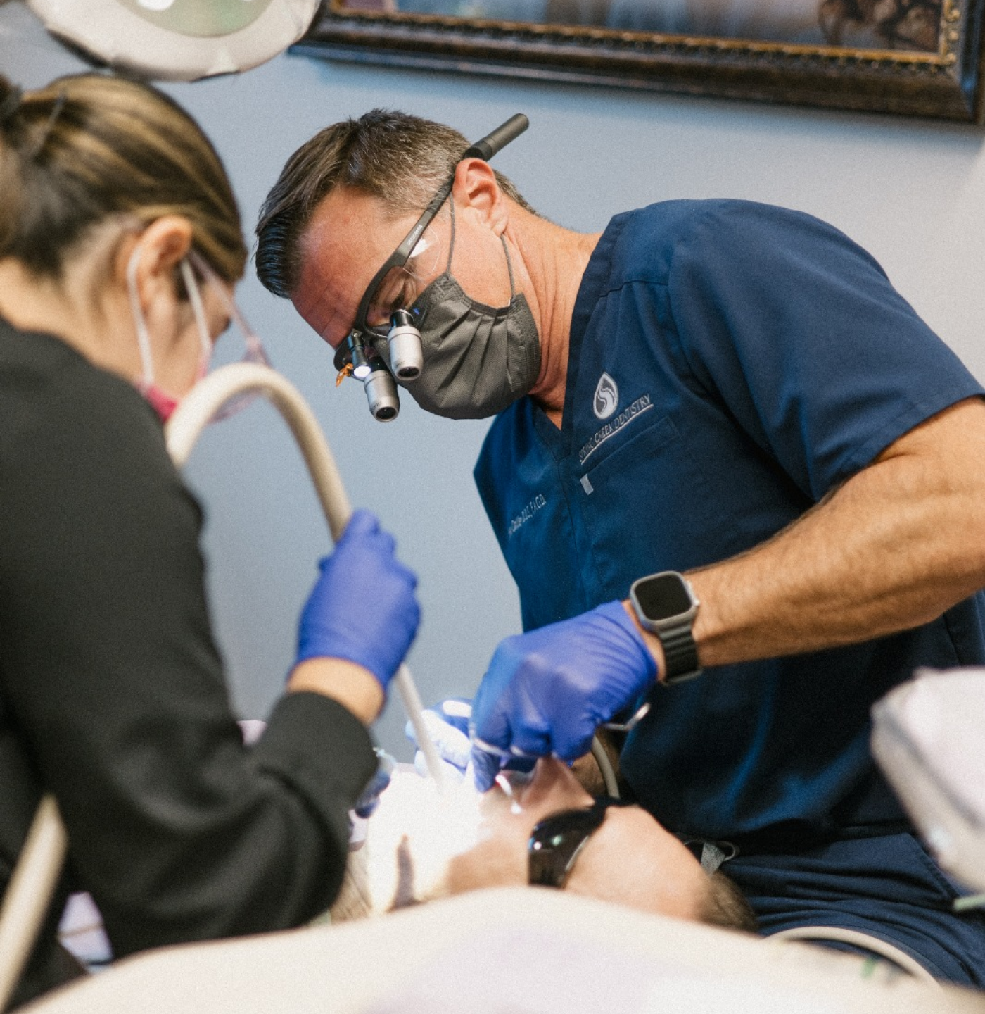 Happy dental patient getting shade-matched for veneers