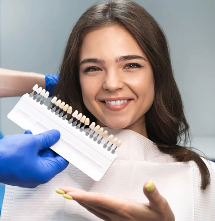 Happy dental patient getting shade-matched for veneers
