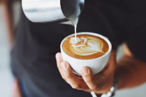 a barista pouring a cappuccino