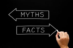 Arrows on chalkboard pointing in different directions for myths and facts 