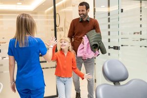 Father and daughter visiting the dentist